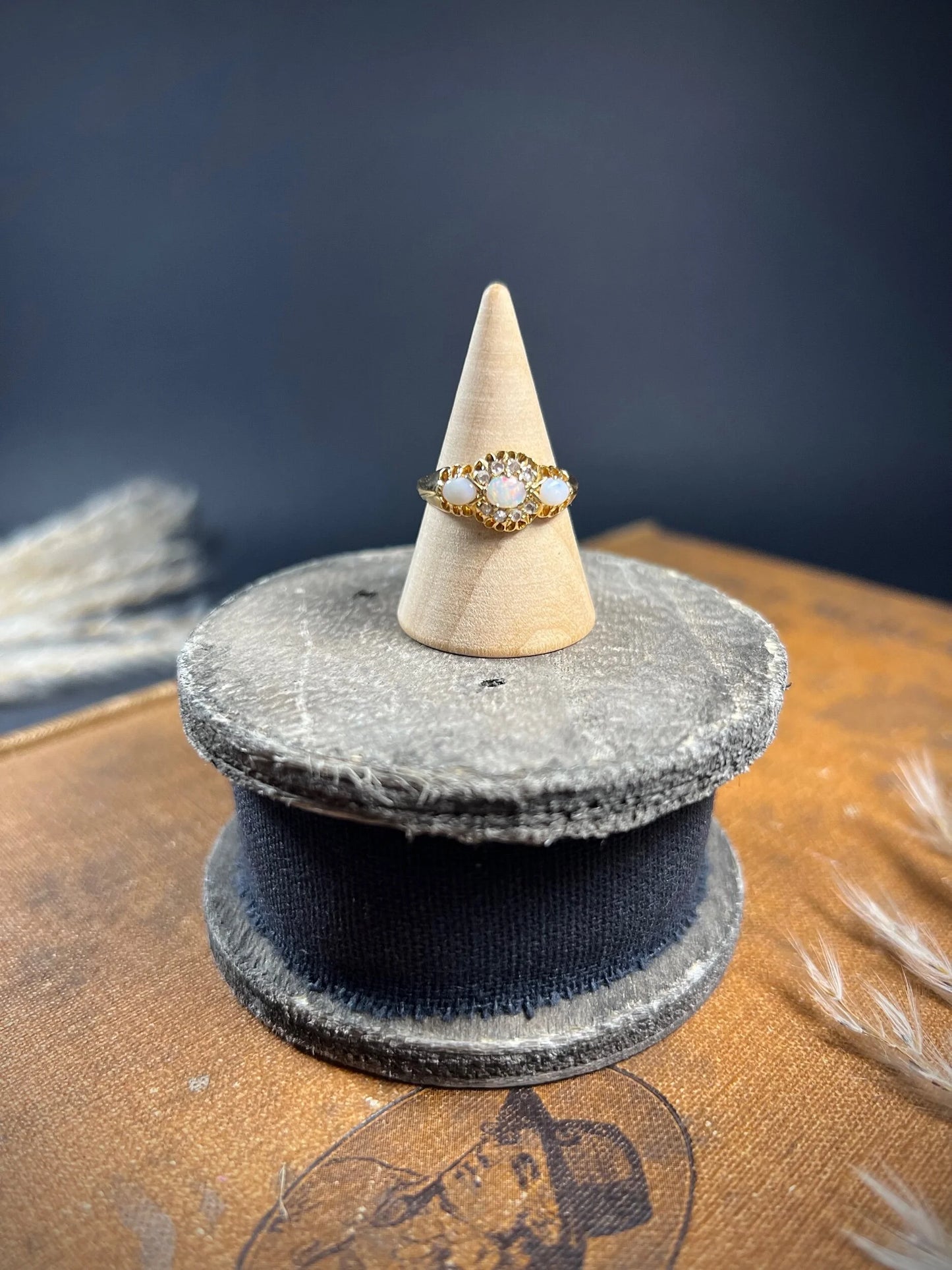 A yellow gold opal and diamond dress ring, on a ring cone