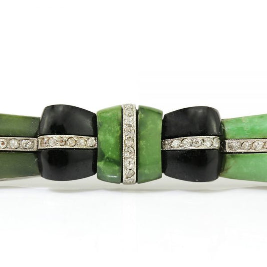 Art Deco Jadeite, Onyx and Old Cut Diamond Bow Brooch in Platinum; set with jadeite accented with onyx and 0.50cts old-cut diamonds, Circa 1920s
