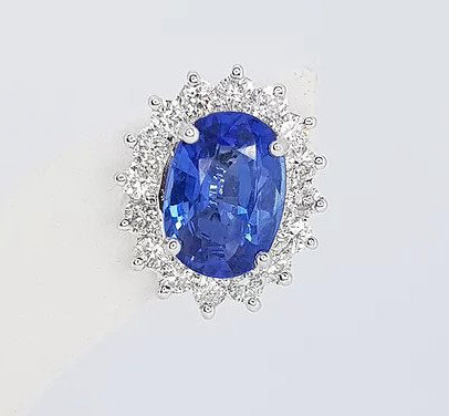 Sapphire and Diamond Oval Cluster Earrings; 2.46cts oval faceted sapphire surrounded by 0.78cts brilliant-cut diamonds, in 18ct white gold.