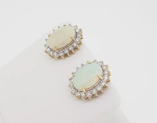 Opal and Diamond Oval Cluster Stud Earrings; featuring 4.00cts oval cabochon opals surrounded by sparkling diamonds, claw set in 18ct gold