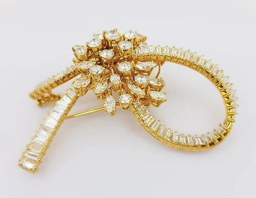 Vintage Multi Cut Diamond Bow Brooch; set with brilliant-cut, marquise-cut and baguette-cut diamonds, 9.00 carat total, mounted in 18ct yellow gold.