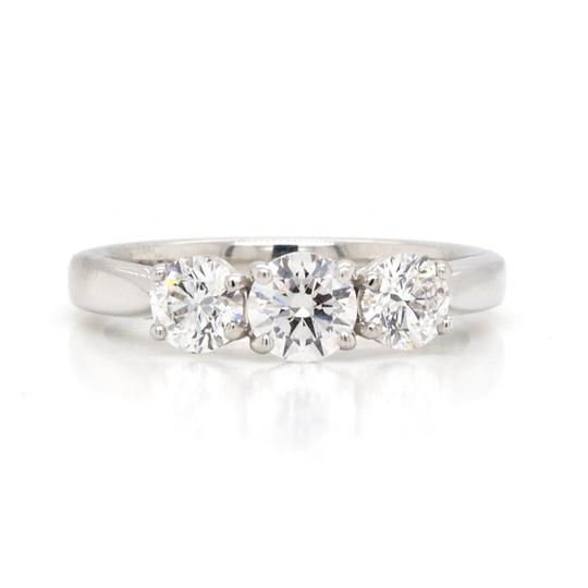 Diamond 1.02ct Three-Stone Ring in Platinum; central 0.40ct round brilliant-cut diamond flanked by smaller diamonds, 1.02ct total, four-claw set, certified