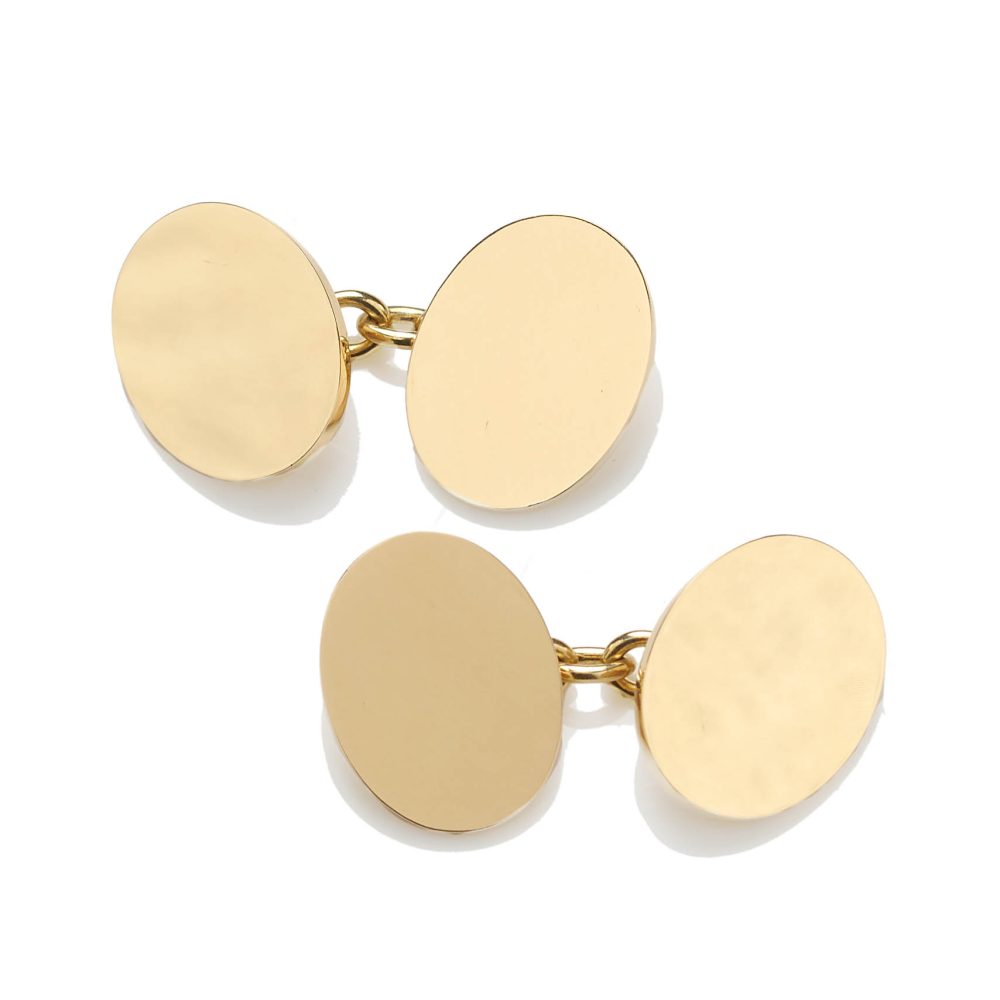 Pair of double sided oval cufflinks in 9 carat yellow gold with chain connection.