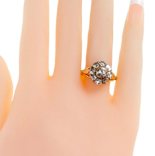 A rose-cut diamond cluster ring in yellow gold, modelled on a hand