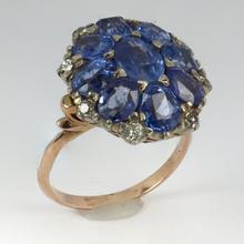 Vintage 8.90ct Sapphire and Diamond Cluster Ring; nine oval sapphires in a floral design, accented with brilliant cut diamonds, in 18ct white and rose gold
