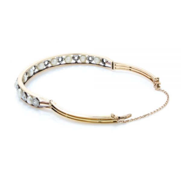 Antique Edwardian Natural Pearl and Old Cut Diamond Bangle Bracelet; set with certified natural saltwater pearls and 2.75cts old cut diamonds, in 15ct gold and platinum