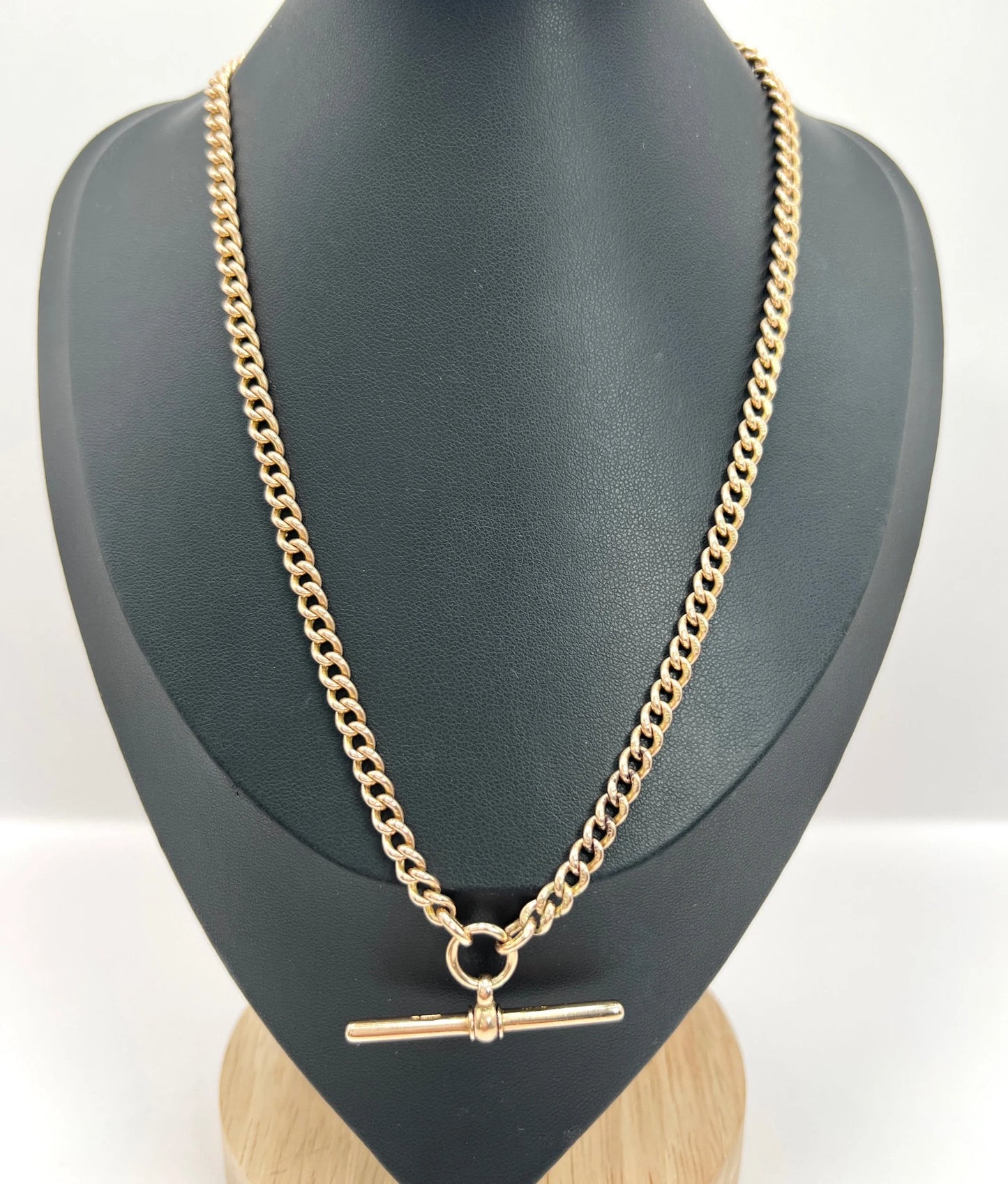 A gold curb link Albert chain, modelled on a black bust