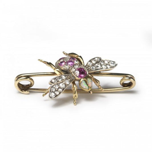 Antique Victorian Diamond, Ruby and Opal Bee Brooch; set with two opals for the eyes, round and cushion-shaped rubies and rose-cut diamonds to the body, and rose-cut diamonds in the wings, in silver and 18ct gold