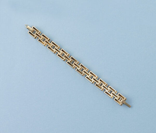 Cartier Gold Retro Bracelet Set With Sapphires; industrial design tank link gold bracelet set with thirty-one French square cut sapphires, Signed and numbered, Circa 1940