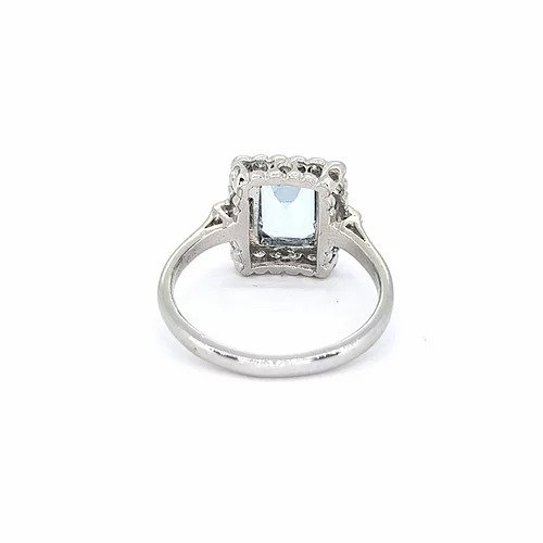 Aquamarine and Diamond Cluster Ring; emerald-cut aquamarine surrounded by round-cut diamonds, baguette-cut diamond set shoulders, in 18ct white gold