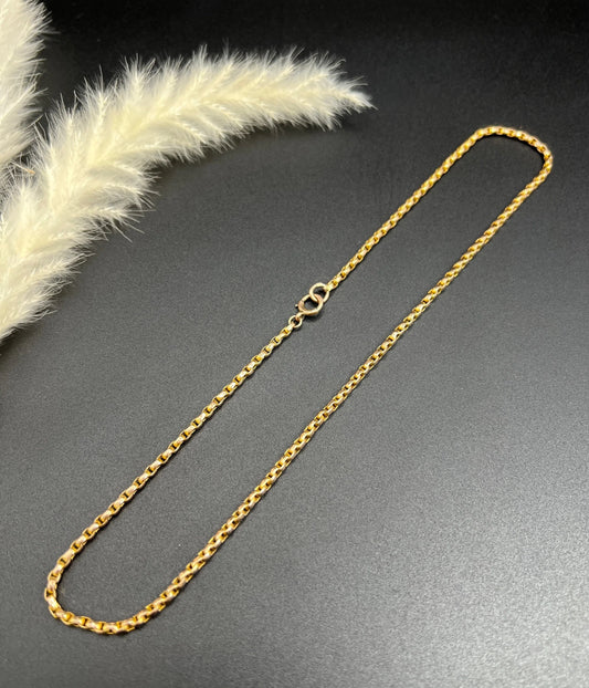 A gold chain necklace with a bolt ring clasp