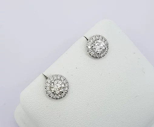Diamond Cluster Stud Earrings; central brilliant cut diamonds, four-claw set, surrounded by a halo of diamonds, 0.94 carats, 18ct white gold