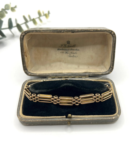 A yellow gold gate style bracelet, in an antique box