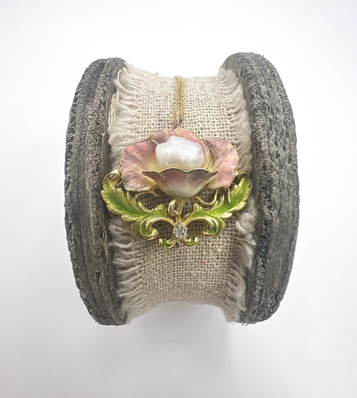 An enamel, diamond and pearl flower pendant with a gold chain