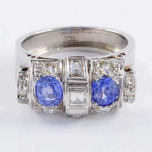 Art Deco 1.60ct Ceylon Sapphire and Old Cut Diamond Two Stone Tank Ring, two Ceylon sapphires with beautiful cornflower blue hue surrounded by old mine-cut diamonds with central raised section of square and rectangular step-cut diamonds in platinum. Circa 1925