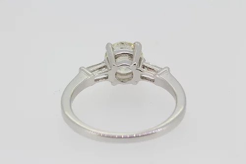 Diamond Solitaire Engagement Ring; central 1.22 carat round brilliant cut diamond with 0.24cts baguette cut diamonds to the shoulders, in 18ct white gold