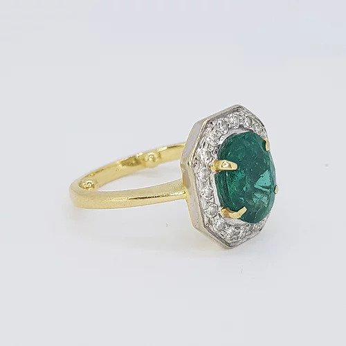 Vintage Natural Colombian Emerald and Diamond Cluster Ring; central 2.50 carat oval faceted natural Colombian emerald surrounded by brilliant-cut diamonds, in 18ct gold, Circa 1970s