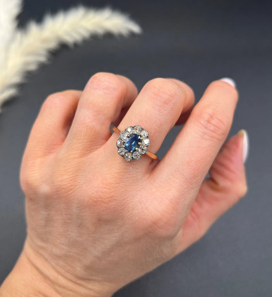 An antique sapphire and diamond oval cluster ring in yellow gold, modelled on a hand