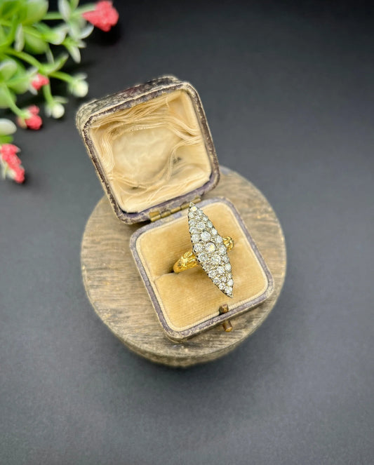A navette shaped diamond cluster ring in yellow gold and silver, in an antique ring box
