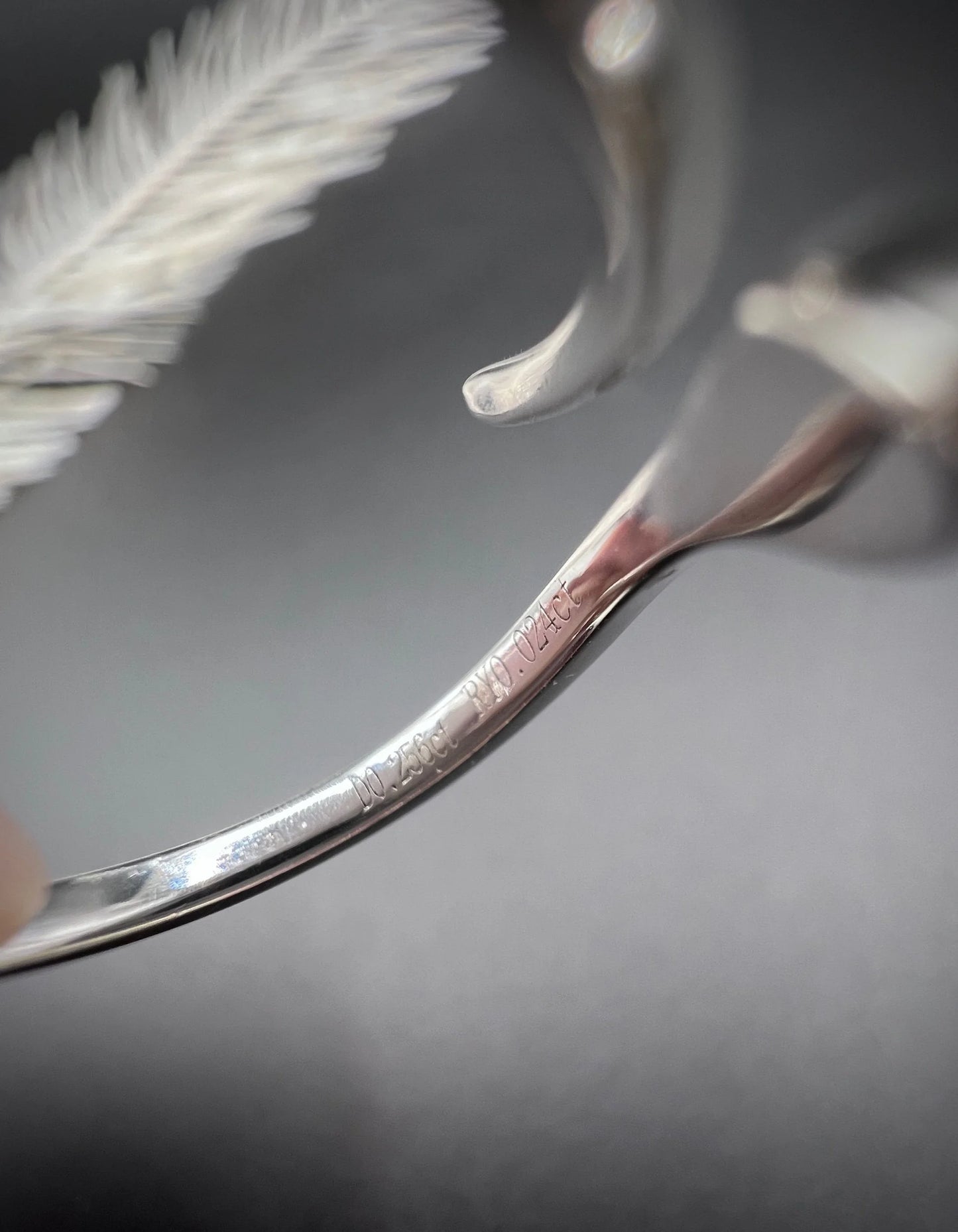 Close-up of stamps inside a white gold ring shank