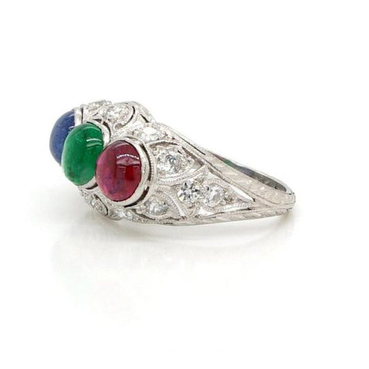 Cabochon Emerald, Ruby and Sapphire Three Stone Ring; mounted in an ornate Edwardian diamond-set pierced platinum mount. Mount Circa 1915
