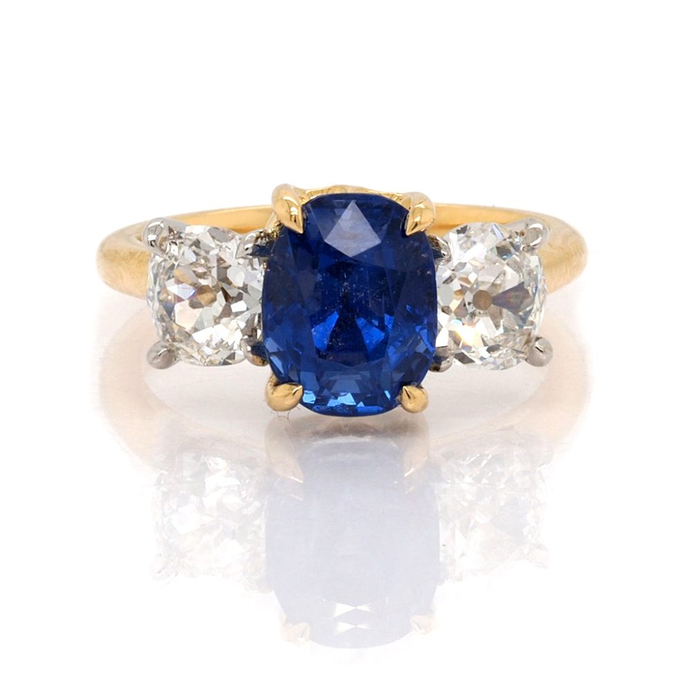 Sapphire and diamond three stone ring in yellow gold.