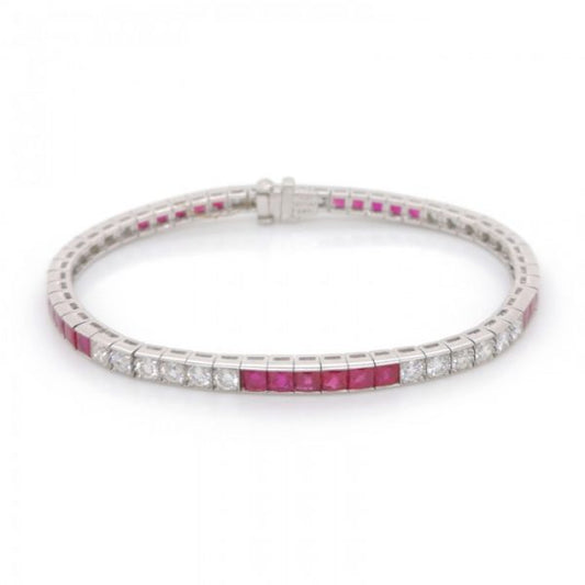 French Cut Ruby and Diamond Line Bracelet in Platinum; set with 2.55cts round brilliant cut diamonds and 23.50cts French-cut rubies, in millegrain edged box settings