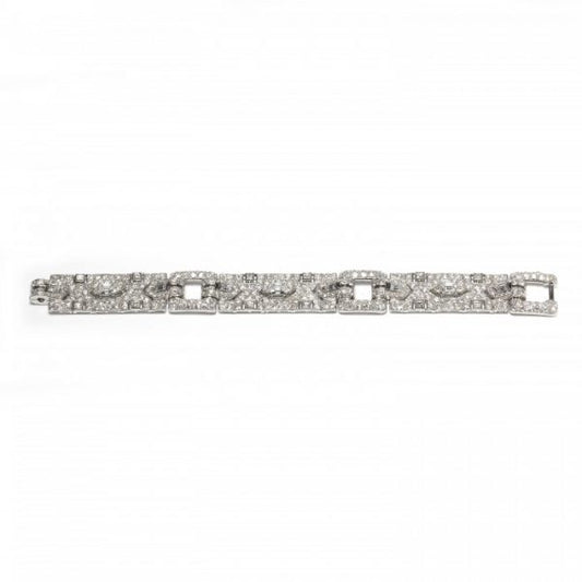 Vintage Cartier Diamond Bracelet; comprised of three panels, each set with a central trap-cut diamond flanked by triangular and fancy-cut diamonds, accented with transitional brilliant-cut and single-cut diamond set surrounds, 18.70 carat total. Mounted in platinum. Circa 1930
