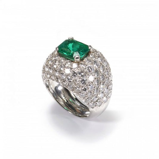 Emerald and Diamond Bombe Cluster Ring, central 2.40ct emerald-cut emerald surrounded by 6cts of brilliant-cut diamonds in a pavé setting, in 18ct white gold