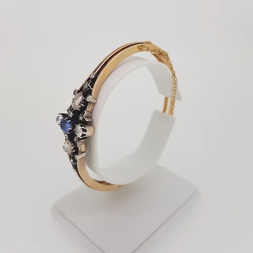 Antique Victorian Natural Sapphire and Old Cut Diamond Bangle Bracelet; central oval faceted natural sapphire surrounded by two white old-cut diamonds and two foiled pink rose-cut diamonds