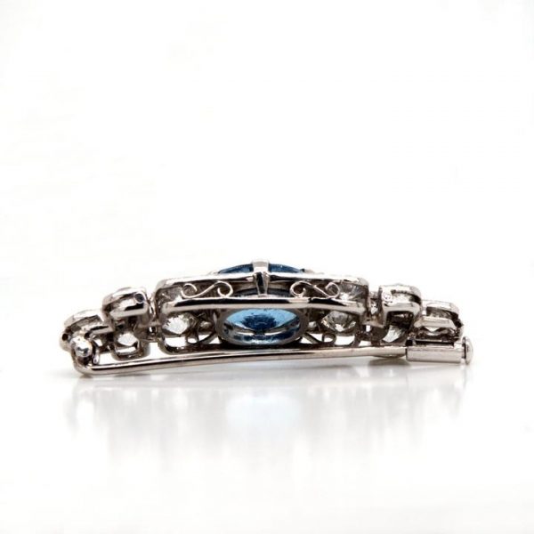 Art Deco Aquamarine, Diamond and Platinum Brooch; vibrant blue oval-cut aquamarine surrounded by 2.50cts old-cut diamonds. Mounted in platinum.
