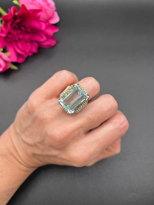 An aquamarine, pearl and diamond large cocktail ring in yellow gold and platinum, modelled on a hand