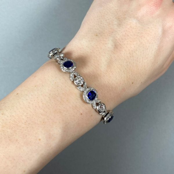 Belle Epoque Burmese Sapphire and Old Cut Diamond Bracelet in Platinum; comprised of round Burmese sapphire and diamond clusters, connected by diamond-set leaf motifs with a round old-cut diamond between each. Circa 1900. Sapphires 5.25 carats, Diamonds 9.50 carats
