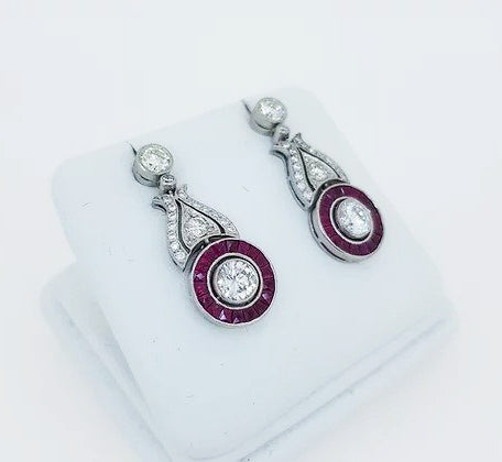 Ruby and Diamond Cluster Drop Earrings; diamond and ruby circular cluster, diamond set scrolls, suspended from diamond stud, 18ct white gold