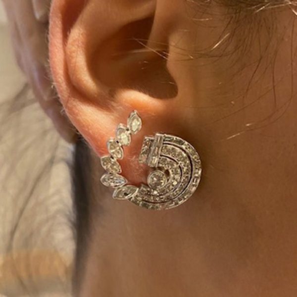 Vintage Diamond Earrings in Platinum; pair diamond scroll earrings, comprising a central round brilliant-cut diamond, surrounded by brilliant and single-cut diamonds, with an outer scroll of baguette and marquise-cut diamonds, 6.75 carat total, Circa 1950s