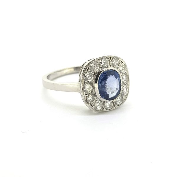 Sapphire and Diamond Cluster Ring; featuring a central 1.10ct oval sapphire surrounded by 0.50cts diamonds, in 18ct white gold