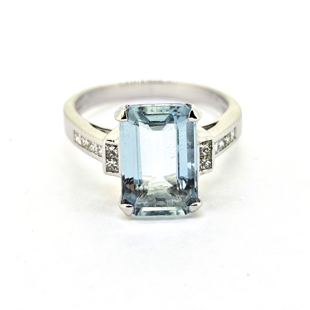 3ct Aquamarine and Princess Cut Diamond Engagement Ring, 3.02ct emerald-cut aquamarine flanked by square princess-cut diamonds in 18ct white gold