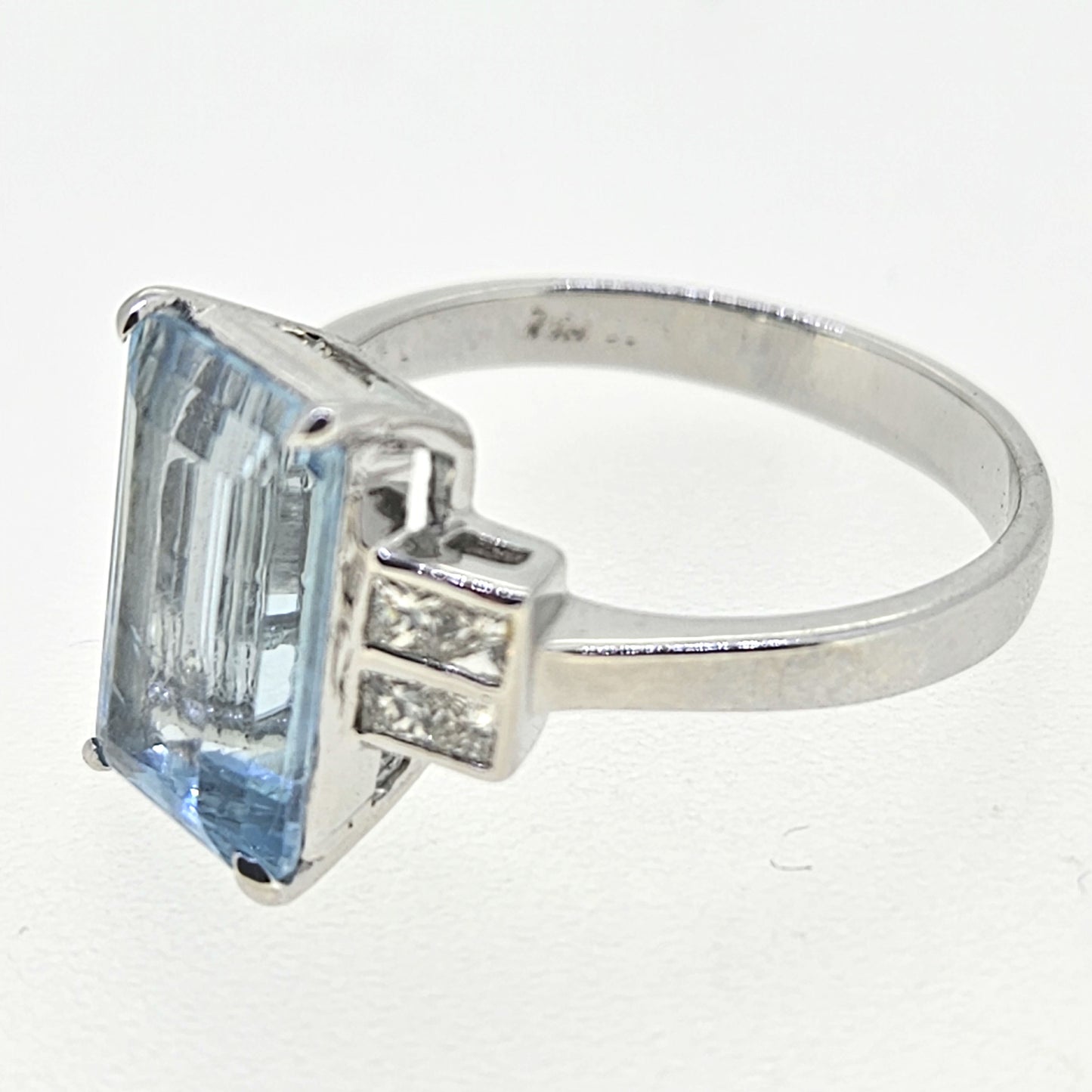 An emerald cut aquamarine and diamond ring in white gold