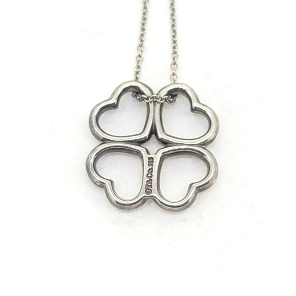 Vintage Tiffany and Co Loving Hearts Silver Pendant with Chain, composed of four loving hearts suspended on a silver chain