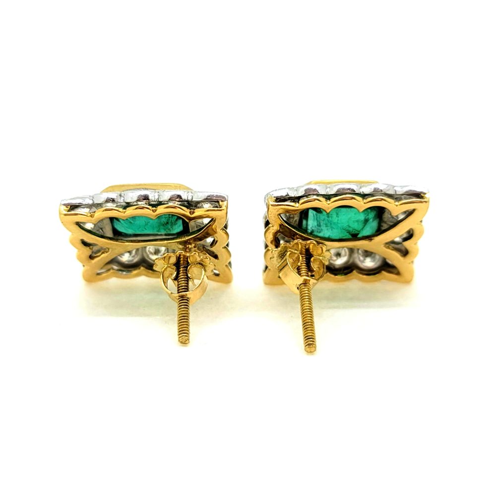 A pair of emerald and diamond rectangular cluster earrings in yellow and white gold, against a white background