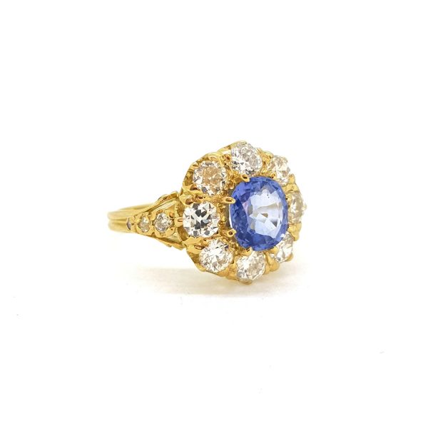 Sapphire and Diamond Cluster Ring; central 1.60ct oval sapphire surrounded by 1.40cts diamonds, in 18ct yellow gold