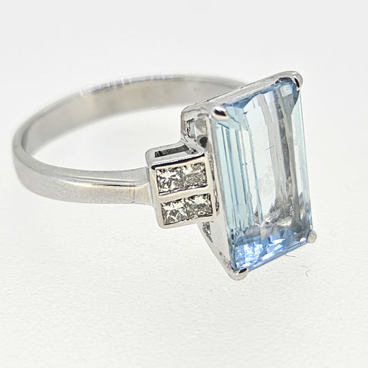 An emerald cut aquamarine and diamond ring in white gold