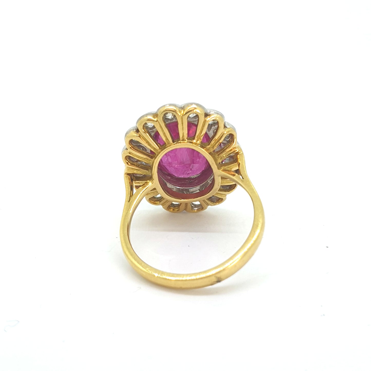 An oval ruby and round diamond scalloped edge cluster ring in yellow and white gold