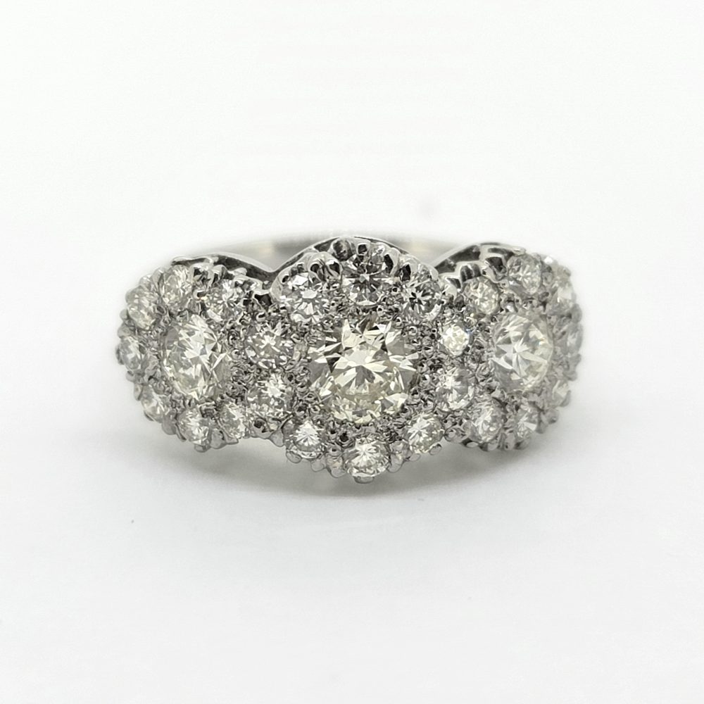 Modern Triple Diamond Cluster Three Stone Trilogy Cluster Ring in Platinum, three principal diamonds all within diamond surrounds, 1.85 carat total