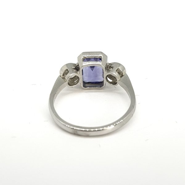 A three stone tanzanite and diamond ring in platinum