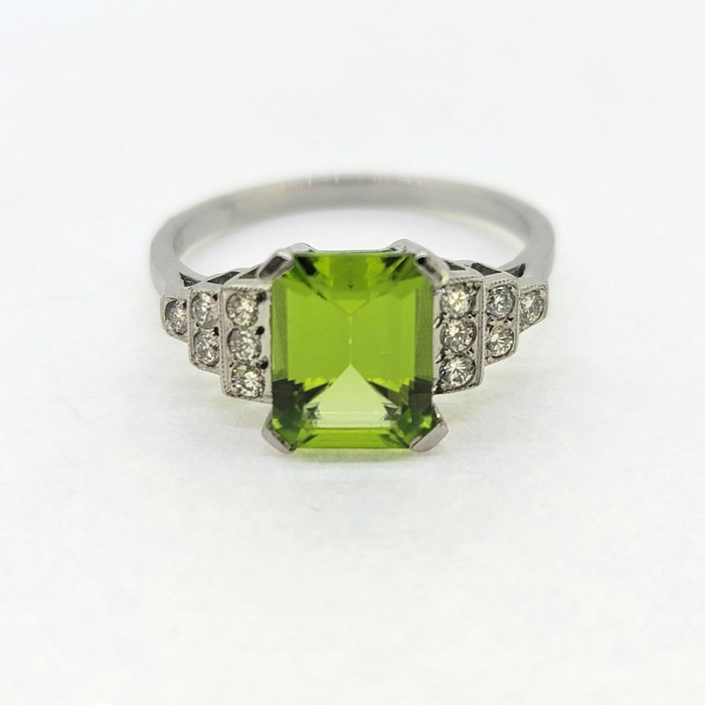 2.40ct Peridot and Diamond Engagement Ring in Platinum, 2.40ct emerald-cut peridot flanked by brilliant-cut diamond set stepped shoulders