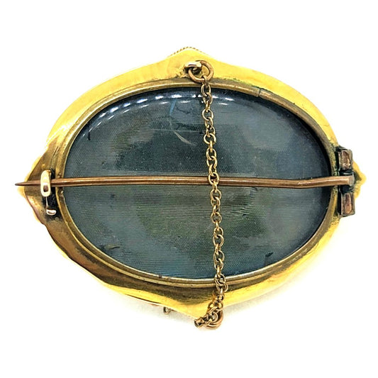 Antique Cabochon Garnet and Gold Locket Brooch, decorative 18ct yellow gold brooch with ball and ropework detailing with central oval cabochon garnet surrounded by white enamel. With locket compartment to reverse