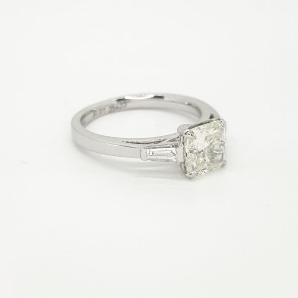 Radiant Cut Diamond Ring with Baguette Shoulders in Platinum; central 0.51 carat radiant-cut diamond flanked by 0.38cts baguette-cut diamonds to the shoulders
