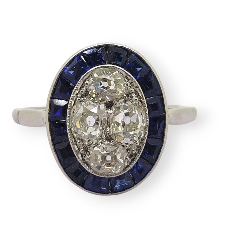 Vintage Sapphire and Diamond Oval Target Cluster Engagement Ring in Platinum, oval cluster of old-cut diamonds with outer border of calibre sapphires