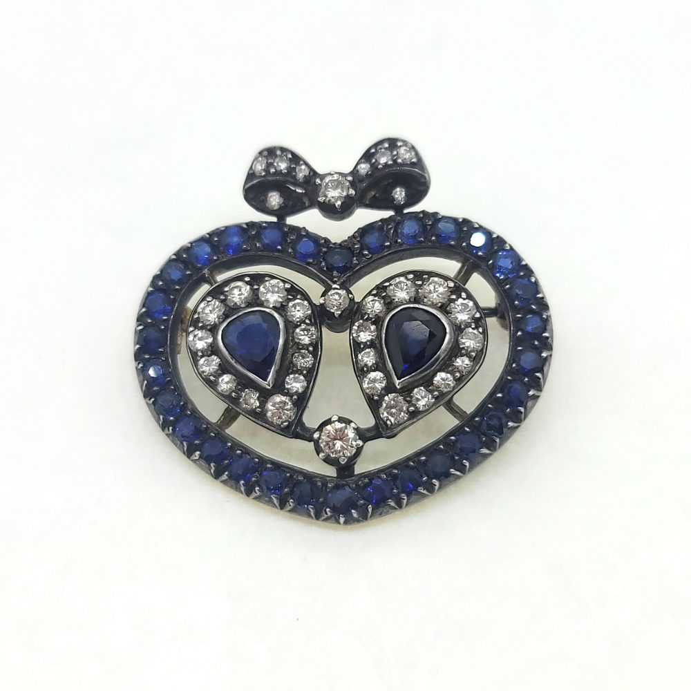 Victorian Antique Sapphire and Diamond Heart Bow Brooch, Two central pear cut sapphire and diamond clusters within sapphire heart shaped surround topped with diamond bow